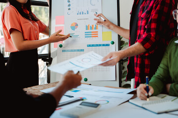 Brainstorming of young modern group. Team meeting to achieve goal. Business people discussing finance business and analysis. Teamwork concept in modern office. Calculating personal tax for client.