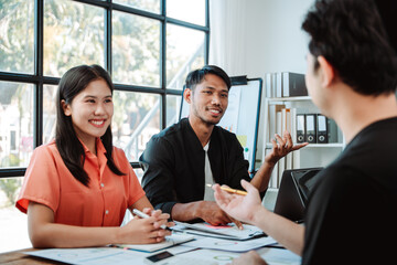 Brainstorming of young modern group. Team meeting to achieve goal. Business people discussing finance business and analysis. Teamwork concept in modern office. Calculating personal tax for client.