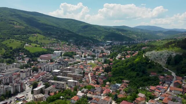 Aerial drone footage of Travnik, Bosnia and Herzegovina, capturing the historic Old Town, Stari Grad fortress, and the surrounding mountain landscape.