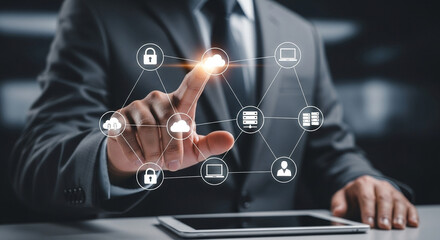 Man in suit interacting with cloud computing icons on a digital interface with a tablet below it