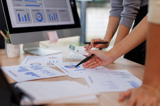 Two business women meeting with analytics in office as web developer in internship, workshop and company. Team, collaboration and digital agency for metrics, growth or career in brand design
