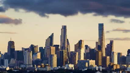 Dynamic timelapse of a modern city skyline at sunset with fast moving clouds over futuristic skyscrapers representing urban development