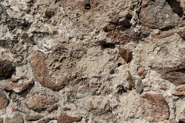 Old rustic stone wall showcasing varied textures in natural light during afternoon hours