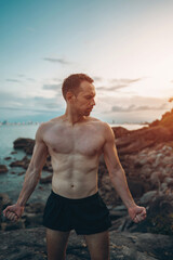 Athlete on rock showcases strength and nature challenge, Muscular athletic climber man at mountain peak radiates fitness and rugged success