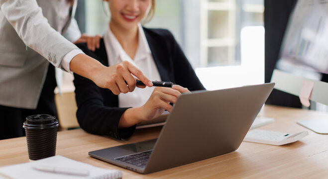 Business asian women Reviewing Documents, Two business meticulously reviewing a stack of documents, highlighting the details and precision in work.	
