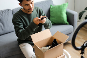 Young Content Creator Taking Photo Of Product Inside Unboxing Box With Smartphone Before Review