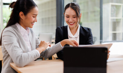 Business Asian meeting, data analytics or women with graph presentation in office for tablet, idea or laptop collaboration. Chart, analysis accounting team brainstorming economy, inflation or solution