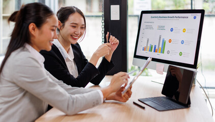 Business Asian meeting, data analytics or women with graph presentation in office for tablet, idea or laptop collaboration. Chart, analysis accounting team brainstorming economy, inflation or solution