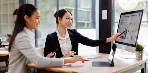 Business people group meeting in the office . Profession asian business women office workers working in team conference with project planning document on meeting table .
