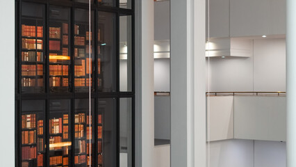 Aged books lined up on rustic wooden bookshelves in an old library interior