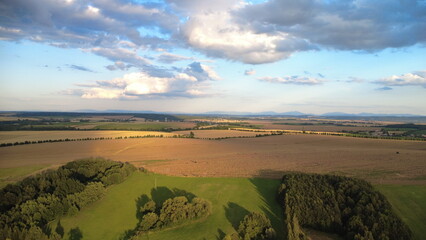Breathtaking sunset over the Czech countryside captured from a drone. Rolling hills, forests, and...