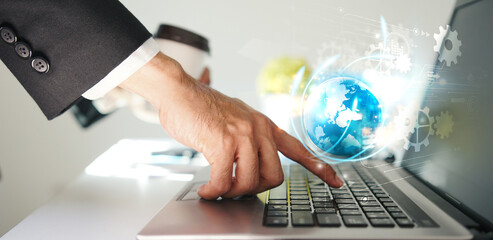 Businessman Using Laptop with Digital Globe Graphic