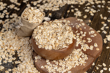 bag with oatmeal flakes, dry cereal flakes from oats, flattened, steamed and dried, close up