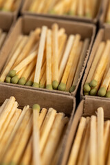 a lot of matches with head in matchbox, the green head of a wooden match laid out in cardboard boxes, closeup