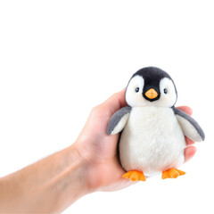 Fototapeta premium Cute penguin plush toy held in hand