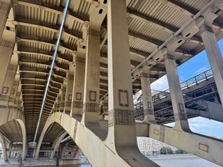 An unusual perspective reveals the complex support structure beneath a massive bridge.
Concept of: Engineering marvel.