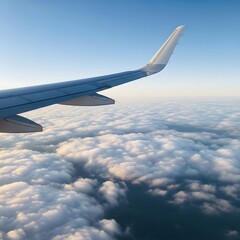 Obraz premium Airplane wing over a vast expanse of puffy clouds.