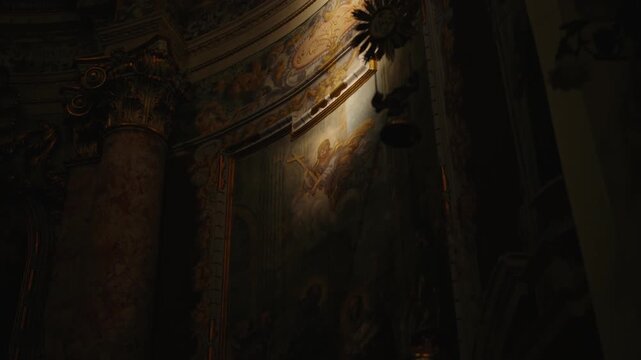Ancient church fresco in the dim light of an old church in Dubrovnik and dimly lit chapel with intricate murals and golden details