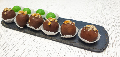 Chocolate candy with nuts, green chocolate, author candy,sale, restaurant, dessert close-up.