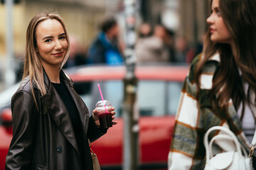 Smiling woman buying pomegranate juice from street vendor