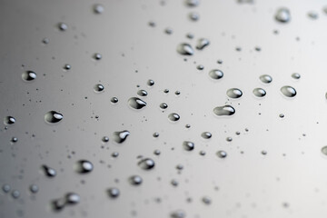 glossy surface covered with water, drops of water makes the waterproof smooth surface completely wet, part of the phone screen is covered with drops of water