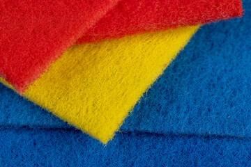 blue, red and yellow synthetic threads for cleaning and washing, closeup