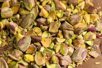 pistachios for cooking , chopped into pieces crispy pistachios fried with salt, close up