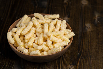 a large number of corn sticks for eating or making breakfast with milk, corn sticks in a wooden bowl