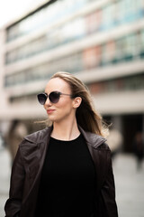 Elegant young woman walking confidently in urban area