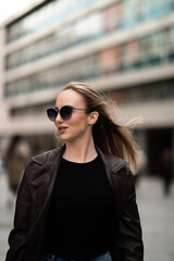 Elegant young woman walking confidently in urban area