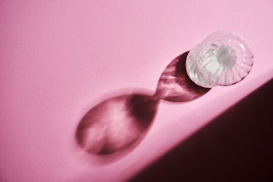 top view hourglass against pink background with copoy space.