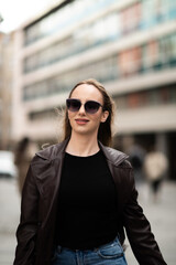 Elegant young woman walking confidently in urban area