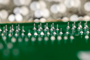 old circuit board with a large number of contacts, a simple green printed circuit board with an electronic circuit with soldered elements