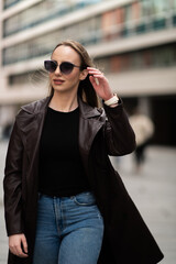 Elegant young woman walking confidently in urban area