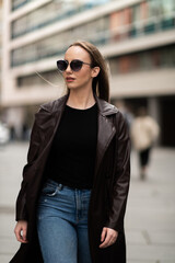 Elegant young woman walking confidently in urban area