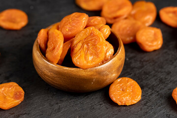 dried apricots from small apricots , dehydrated in the sun and without seeds, dried fruits in a bowl