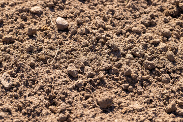 soil dried under the warm spring sun in a field, a plowed agricultural field prepared for planting in the spring season