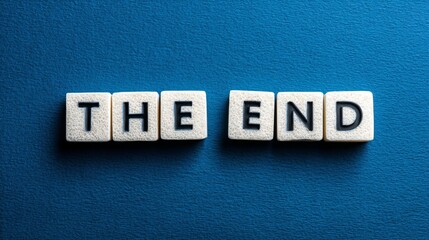 Obraz premium A conceptual photograph with a solid blue background, featuring white letter blocks arranged to spell out 