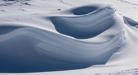 Abstract snow formation in pristine winter landscape with smooth curves and shadows