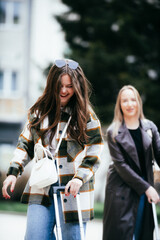 Young women with suitcases traveling and talking outside