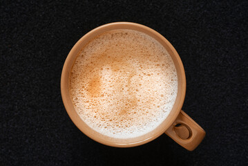 top view coffee cup with cappuccino latte foam on black background