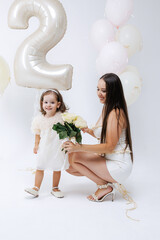 Celebrating two years with a joyful girl and her smiling mother