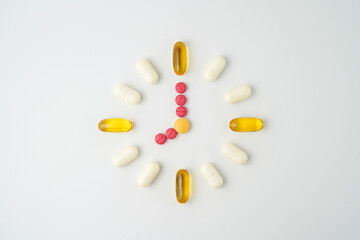 Clock made of pills capsules, pills form a circle, omega, vitamins, Cod liver oil, supplements