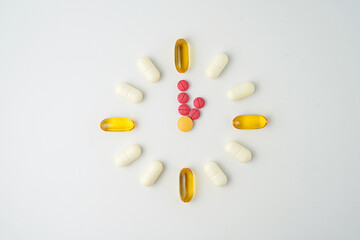 Clock made of pills capsules, pills form a circle, omega, vitamins, Cod liver oil, supplements