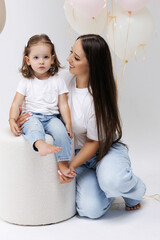 Happy mother and daughter enjoying a moment during a celebration in a light-filled space