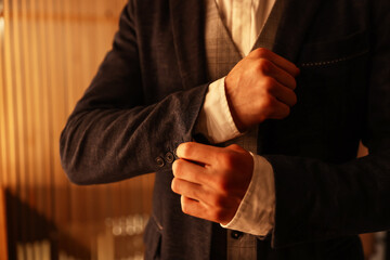 Man in stylish outfit getting ready indoors, closeup