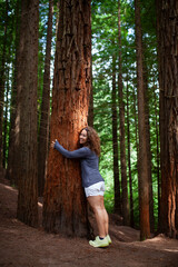 Woman embracing sequoia in Monte de las Navas, Cabez&oacute;n de la Sal (Cantabria, Spain).