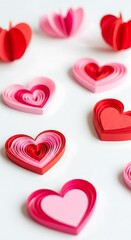 Fototapeta premium Multi-layered paper hearts in varying shades of red and pink.