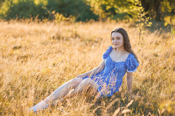 Young woman relaxes in golden field during sunny afternoon