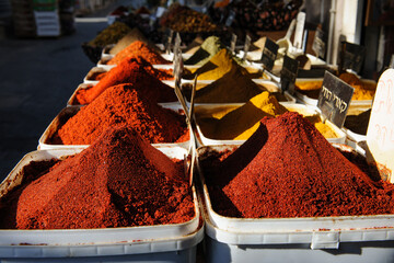 A variety of spice powders, including cumin, smoked paprika, turmeric, za'atar and hot paprika on sale in a spice stall iin Tel Aviv's outdoor Carmel Market.